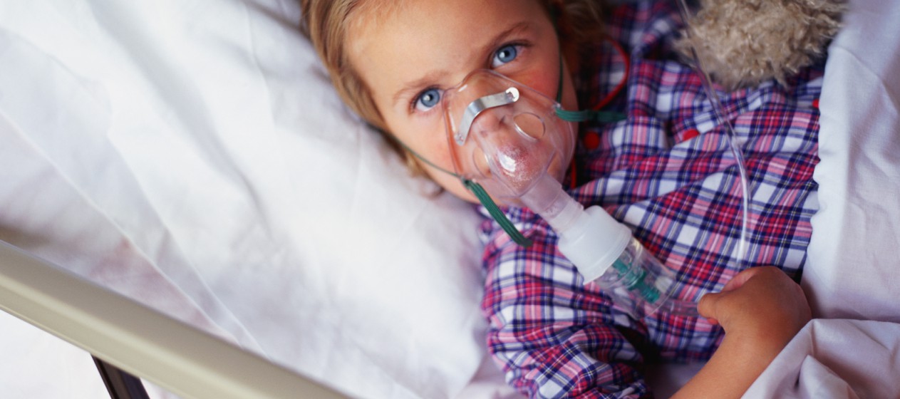 Kind im Bett mit Sauerstoff-Maske